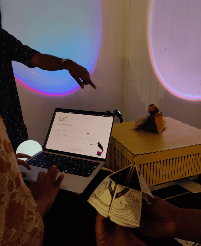 Hands at the laptop with a folded kundli and the printer casing